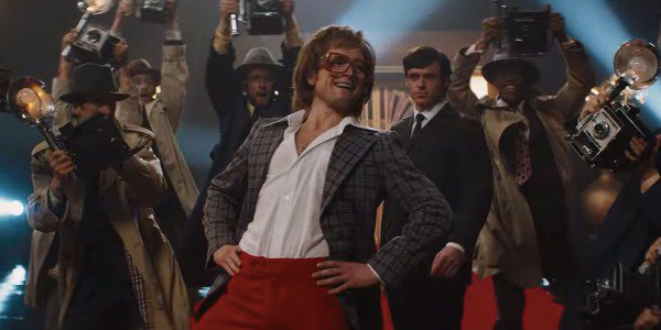 Elton John (Taron Egerton) poses for the cameras in a scene from "Rocketman"